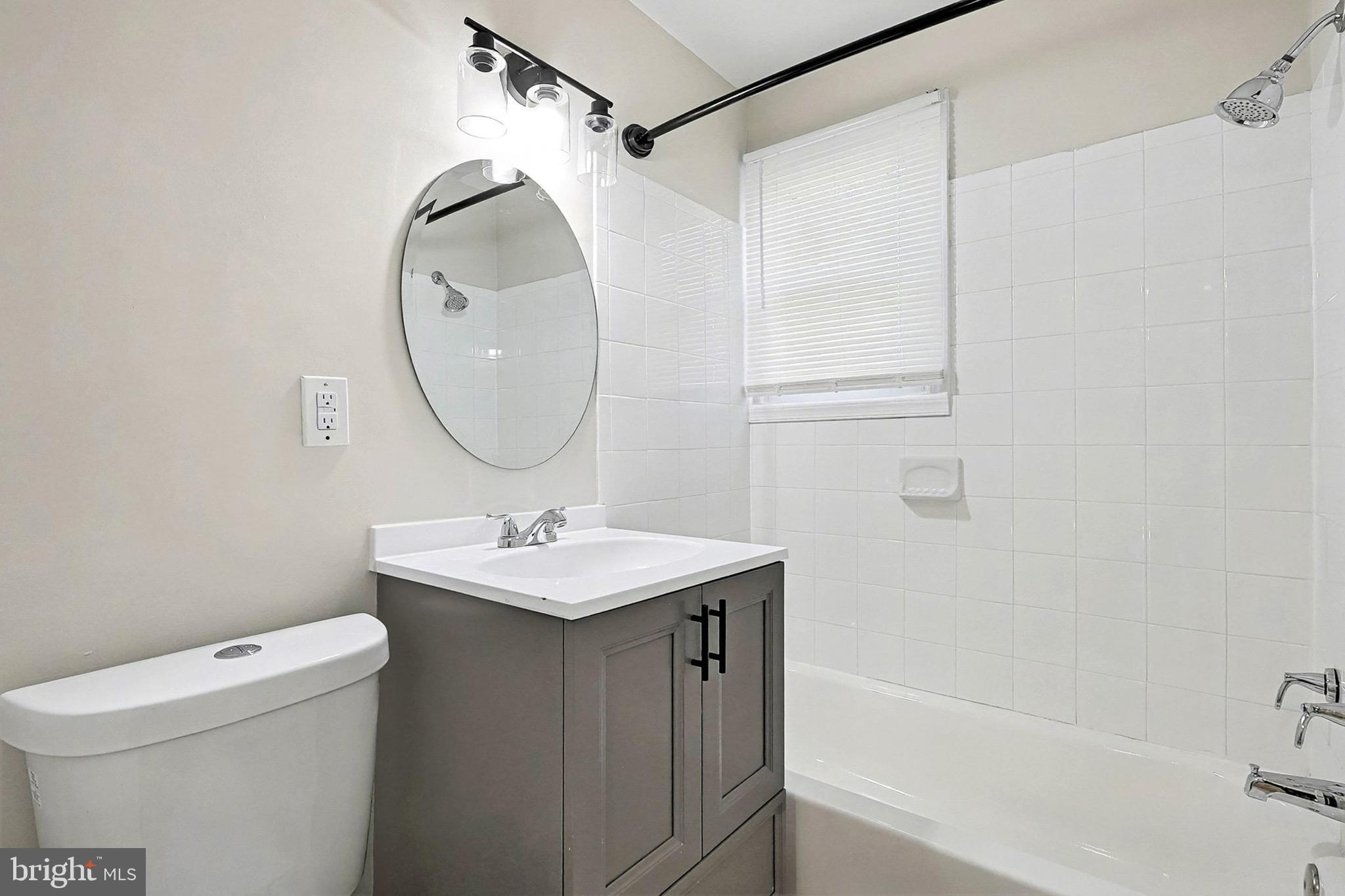 40 East Reed Avenue Alexandria, VA 22305 - Photo 10 of 19 a bathroom with a sink a toilet and a mirror