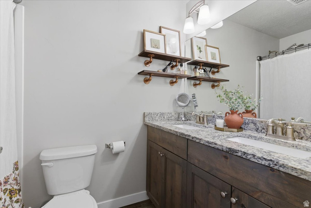 370 West Knights Lane Layton, UT 84041 - Photo 24 of 31 Double vanity featuring a granite countertop with two integrated sinks and brushed nickel faucets