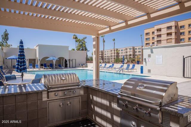 7830 East Camelback Road, Unit 708 Scottsdale, AZ 85251 - Photo 16 of 21 a kitchen with a sink and cabinets