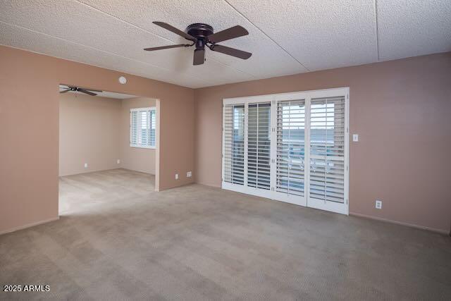 7830 East Camelback Road, Unit 708 Scottsdale, AZ 85251 - Photo 5 of 21 a view of an empty room with a window and a ceiling fan