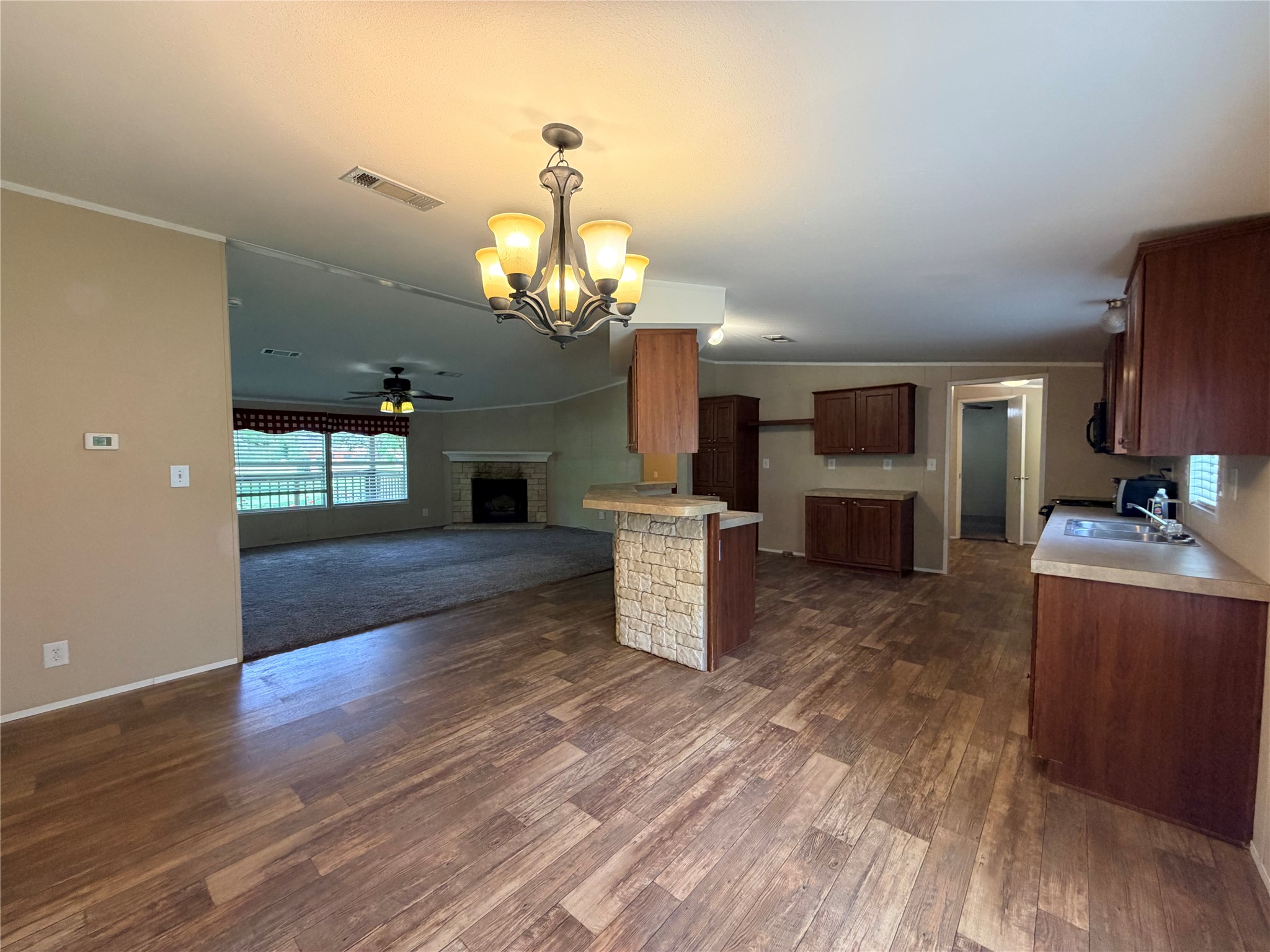 263 Camden Road Chester, TX 75936 - Photo 16 of 49 a view of a kitchen with a sink and dishwasher a kitchen island with wooden floor