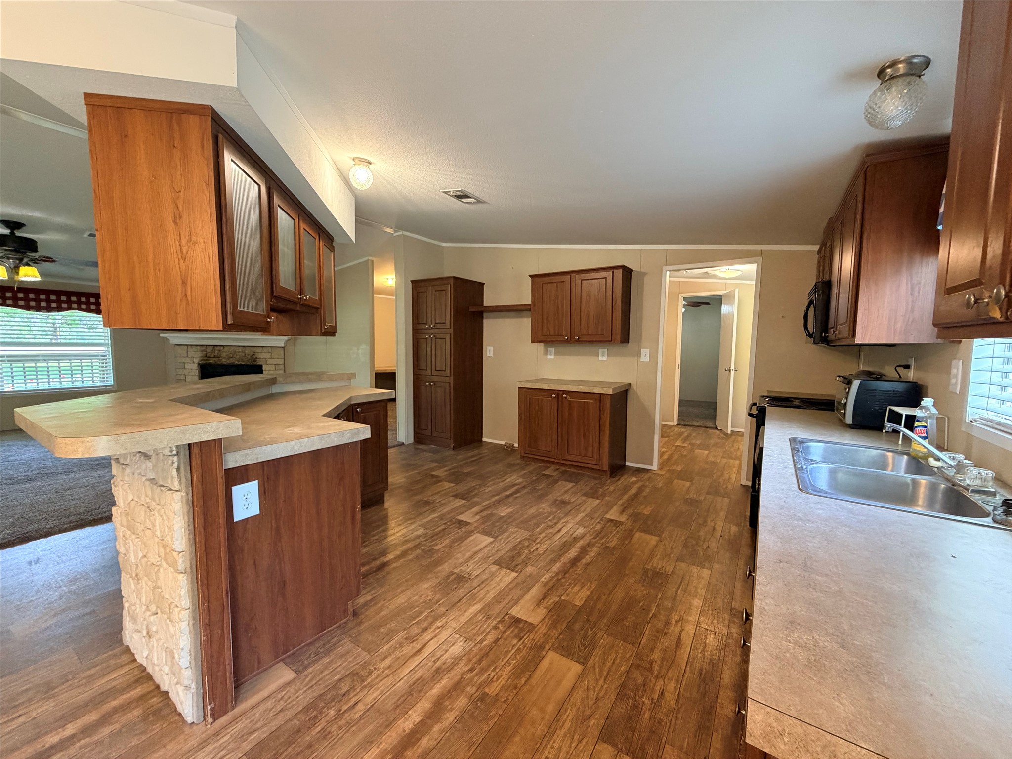 263 Camden Road Chester, TX 75936 - Photo 17 of 49 a kitchen with stainless steel appliances granite countertop a sink a stove top oven a refrigerator cabinets and wooden floor