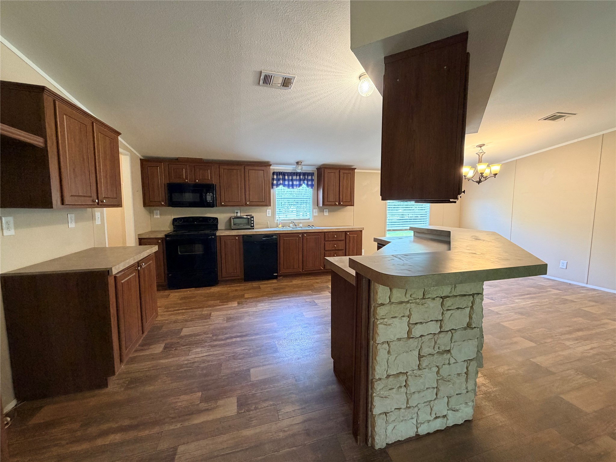 263 Camden Road Chester, TX 75936 - Photo 21 of 49 a kitchen with stainless steel appliances granite countertop a stove top oven a sink dishwasher and a microwave oven on the wooden floor