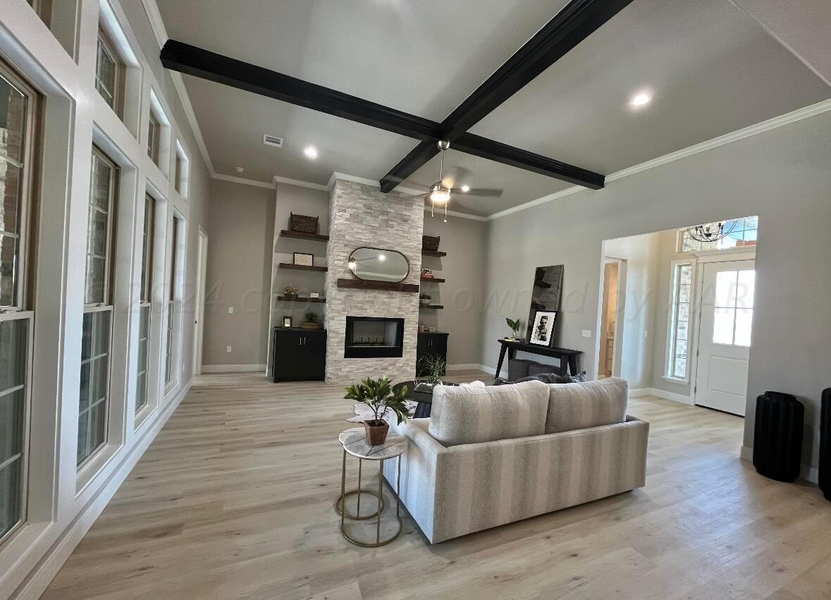 7616 Bluestone Drive Amarillo, TX 79119 - Photo 4 of 10 a living room with furniture and a fireplace