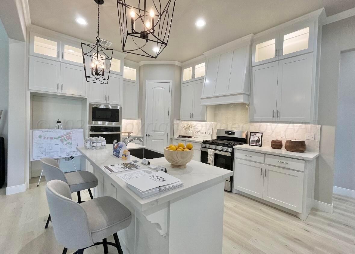 7616 Bluestone Drive Amarillo, TX 79119 - Photo 6 of 10 a kitchen that has a lot of cabinets in it