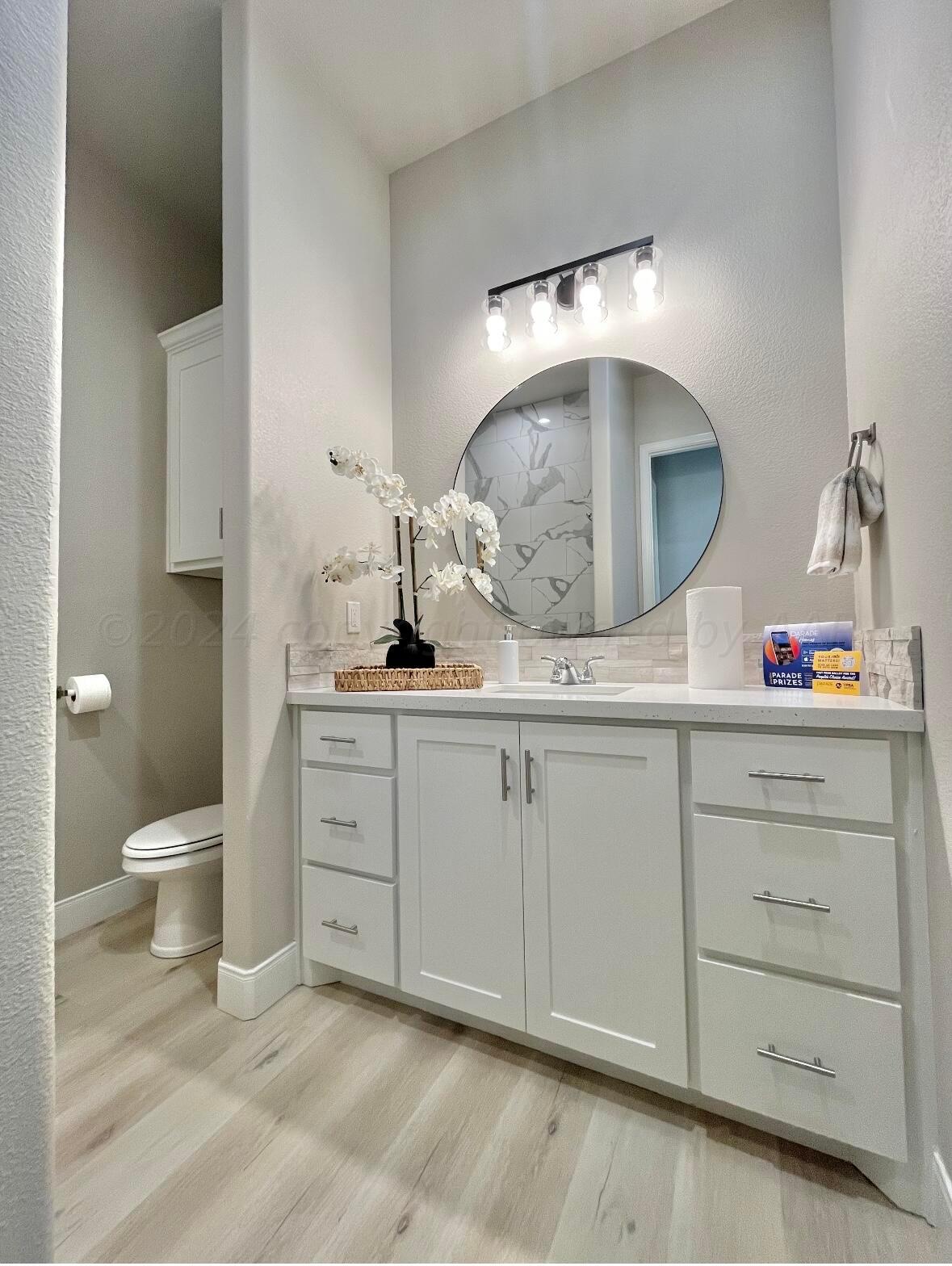 7616 Bluestone Drive Amarillo, TX 79119 - Photo 9 of 10 a bathroom with a sink and a mirror