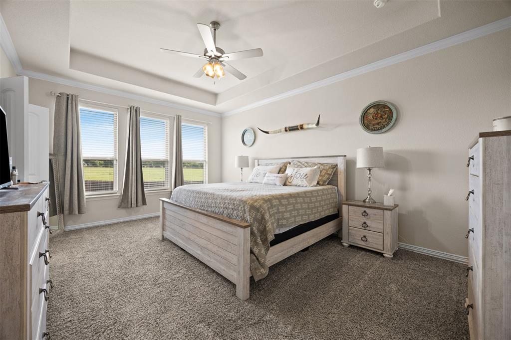 2618 Byrd Ranch Road Midlothian, TX 76065 - Photo 22 of 38 a bedroom with a bed and a chandelier