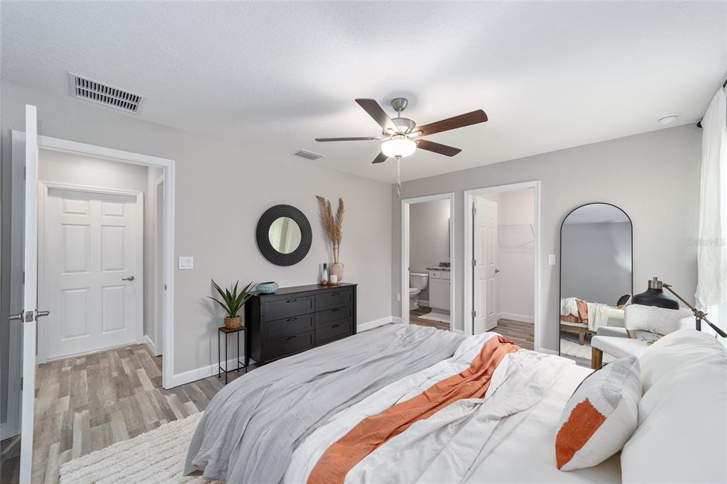 8571 Southwest 131st Place Ocala, FL 34473 - Photo 21 of 32 a bedroom with a bed and a chandelier