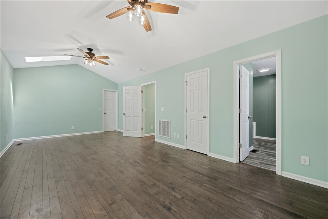 210 Briarcliff Road Central, SC 29630 - Photo 24 of 39 Spacious room with elegant hardwood flooring, vaulted ceilings, and a skylight.