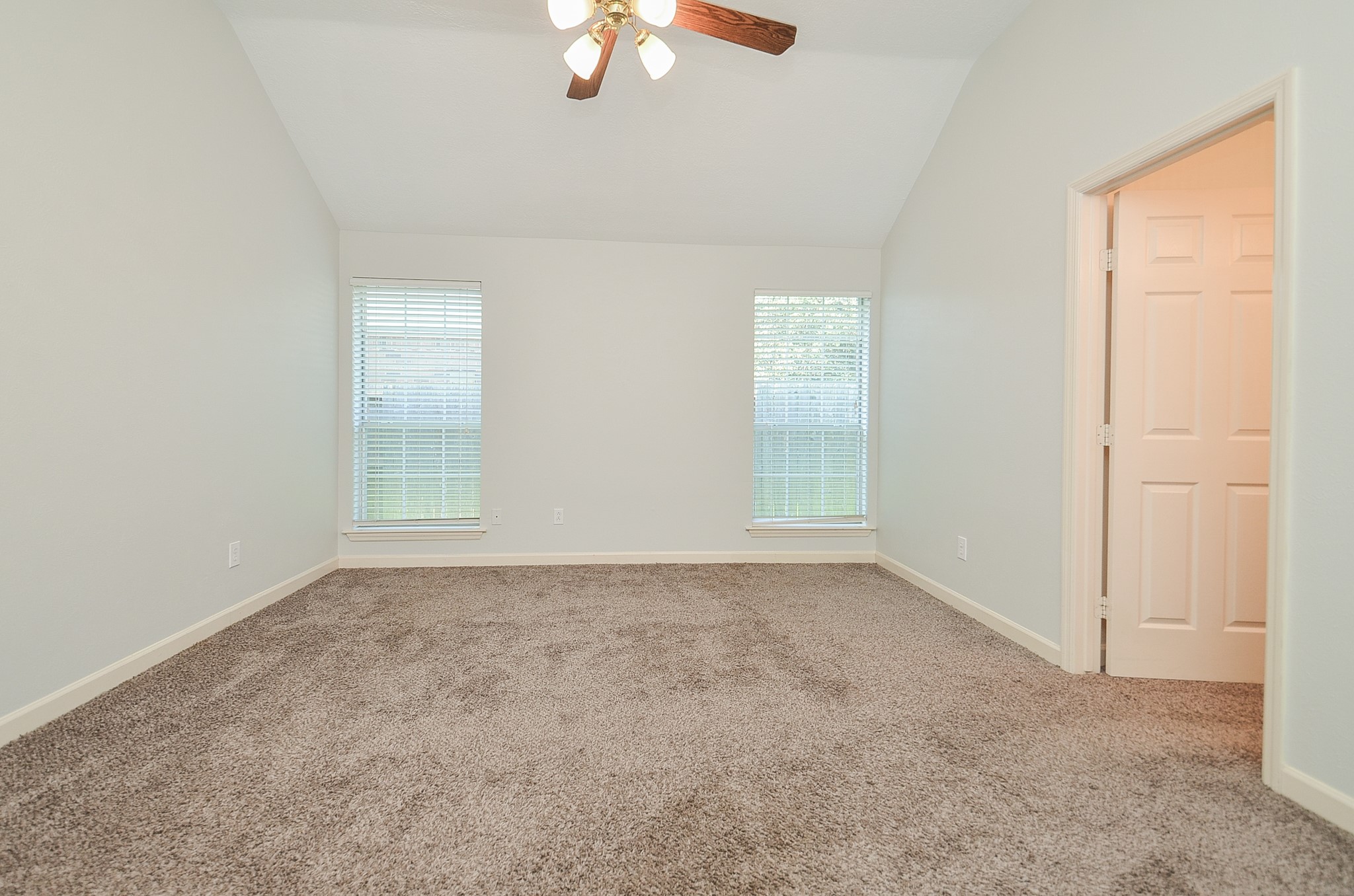 811 Spring Valley Court Sugar Land, TX 77479 - Photo 12 of 33 an empty room with windows and chandelier fan