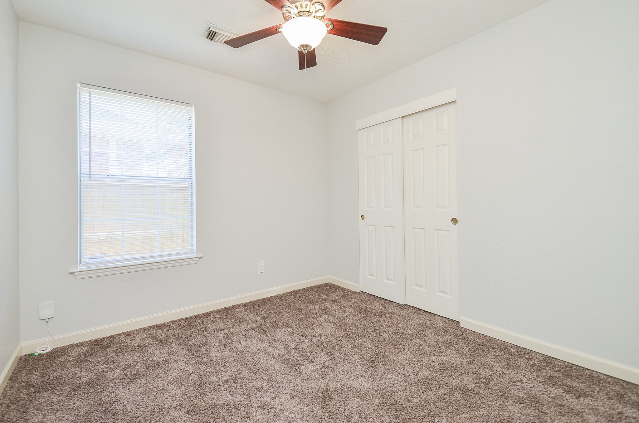 811 Spring Valley Court Sugar Land, TX 77479 - Photo 16 of 33 an empty room with a window and a fan