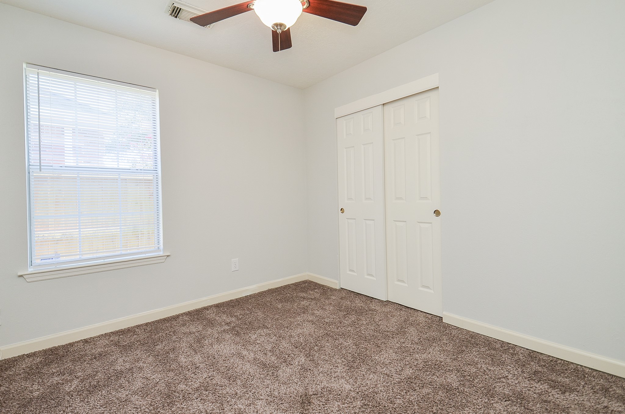 811 Spring Valley Court Sugar Land, TX 77479 - Photo 17 of 33 an empty room with a window and a fan