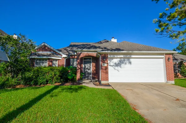 a front view of a house with a garden and yard