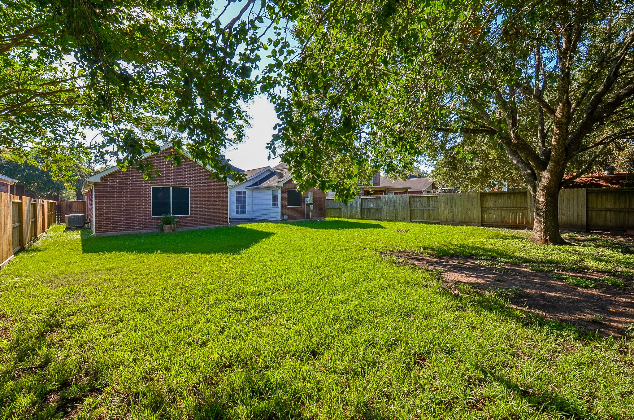 811 Spring Valley Court Sugar Land, TX 77479 - Photo 24 of 33 a view of a house with yard and tree s