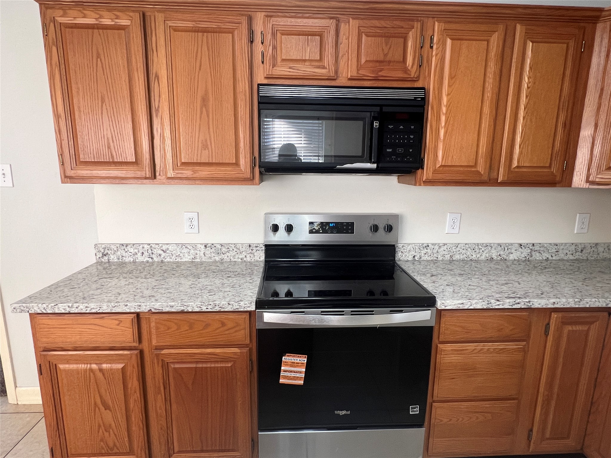 811 Spring Valley Court Sugar Land, TX 77479 - Photo 27 of 33 a kitchen with granite countertop wood cabinets stainless steel appliances and a sink