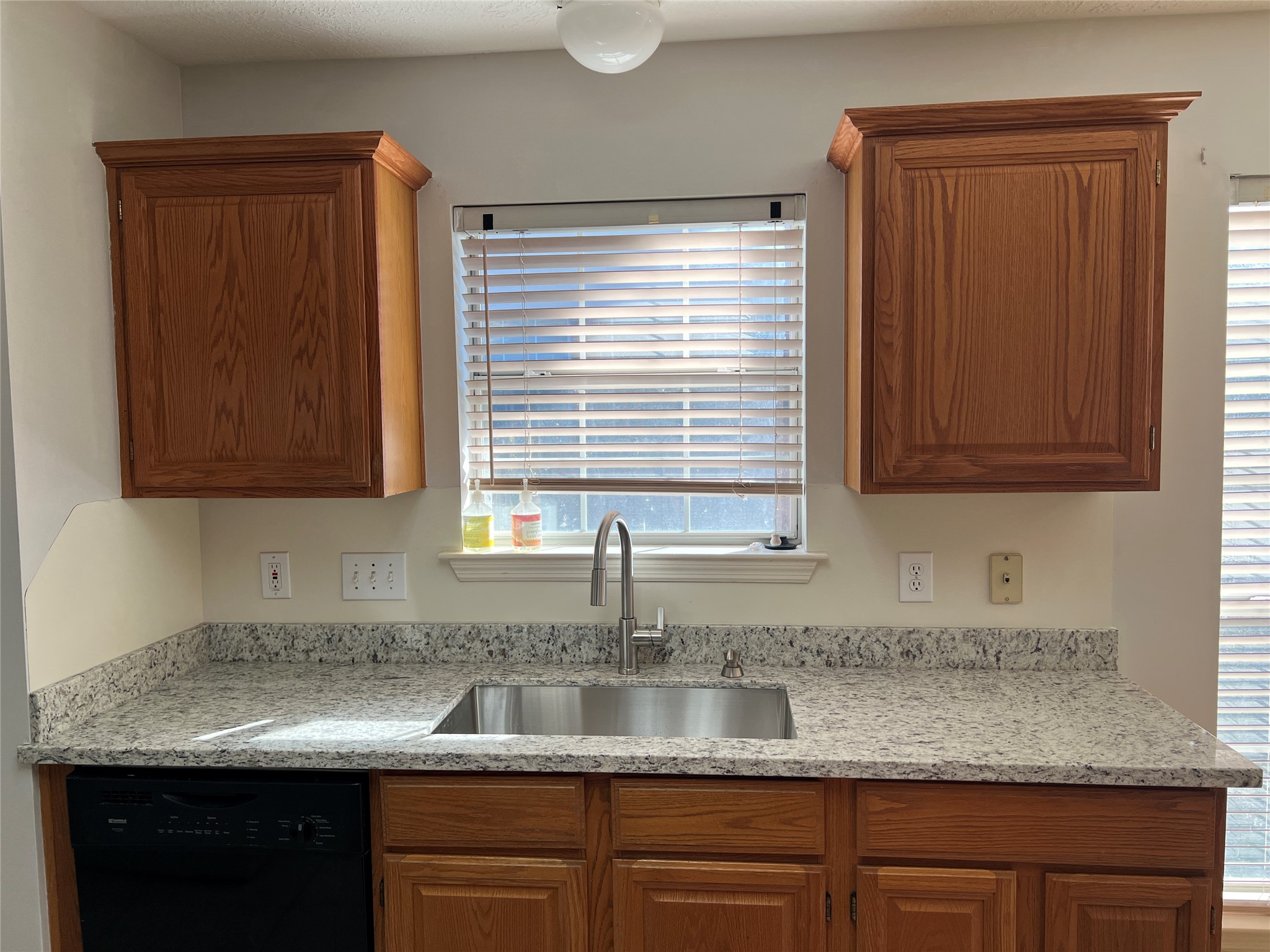 811 Spring Valley Court Sugar Land, TX 77479 - Photo 28 of 33 a kitchen with granite countertop cabinets sink and window