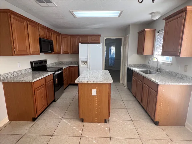 a bathroom with a tub double sink and mirror