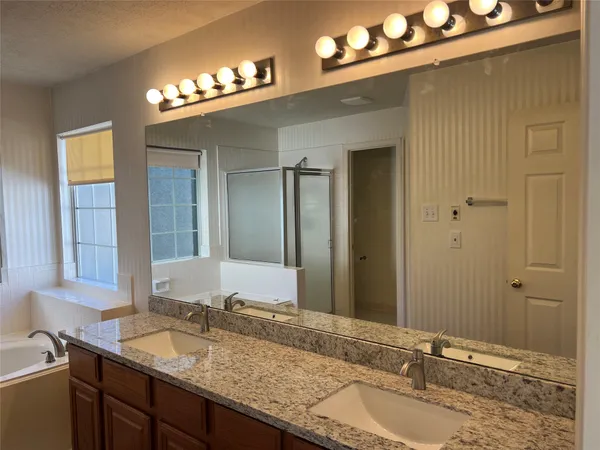 a bathroom with a granite countertop sink and a mirror
