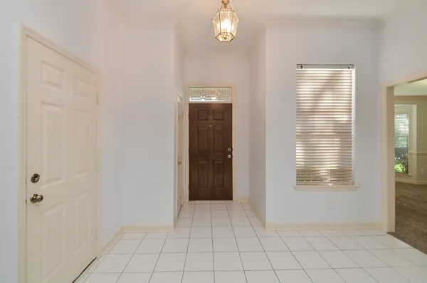 a view of an entryway with wooden floor and windows