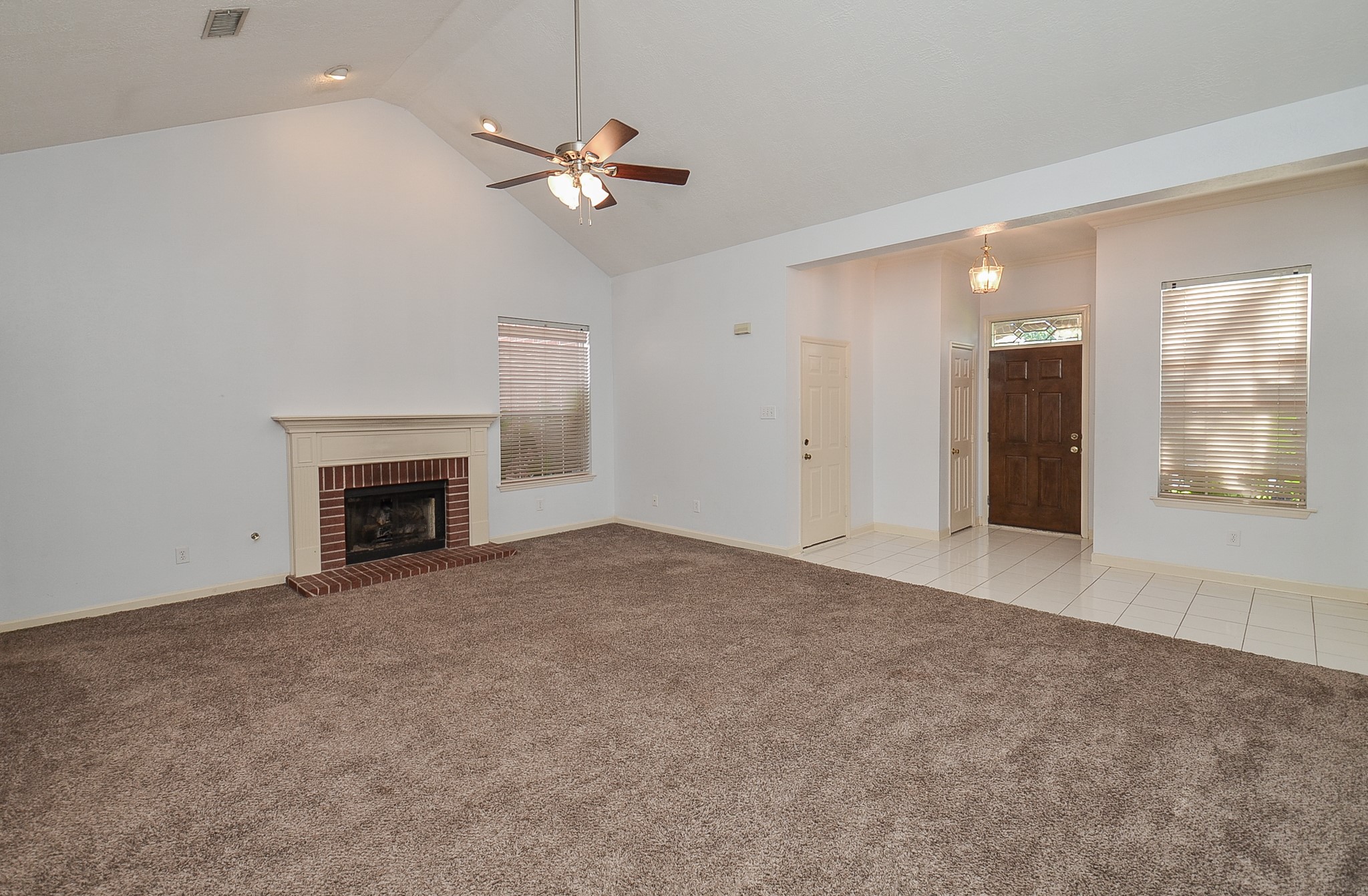 811 Spring Valley Court Sugar Land, TX 77479 - Photo 9 of 33 a view of an empty room with chandelier fan and fire place