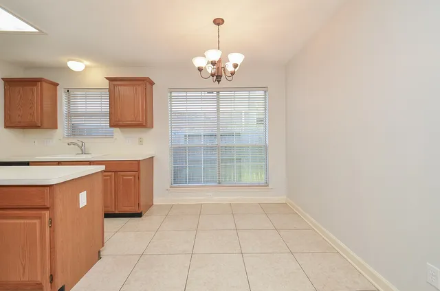 a kitchen with stainless steel appliances a sink stove and cabinets