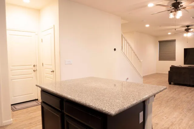 a kitchen with a sink a counter and a refrigerator