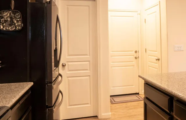 a kitchen with a refrigerator and cabinets