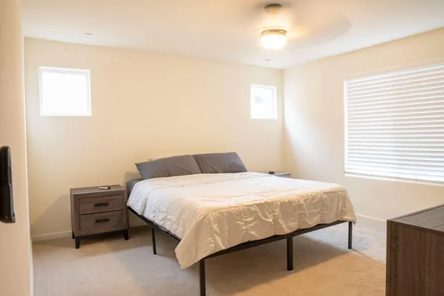 a bedroom with a bed and a chandelier