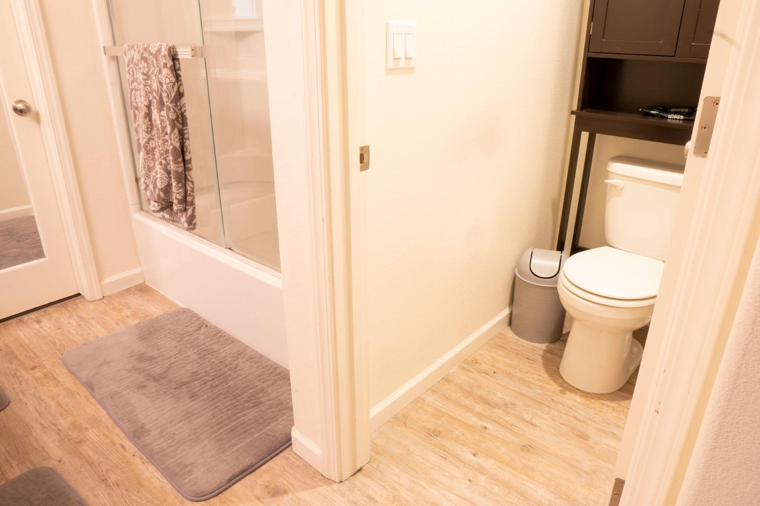 6974 East Atchison Street Fresno, CA 93727 - Photo 21 of 40 a bathroom with a toilet and a shower