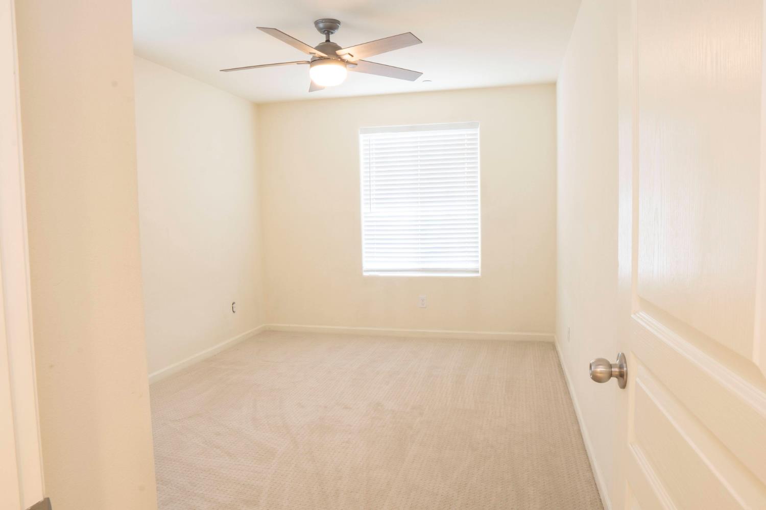 6974 East Atchison Street Fresno, CA 93727 - Photo 27 of 40 an empty room with a window and a fan