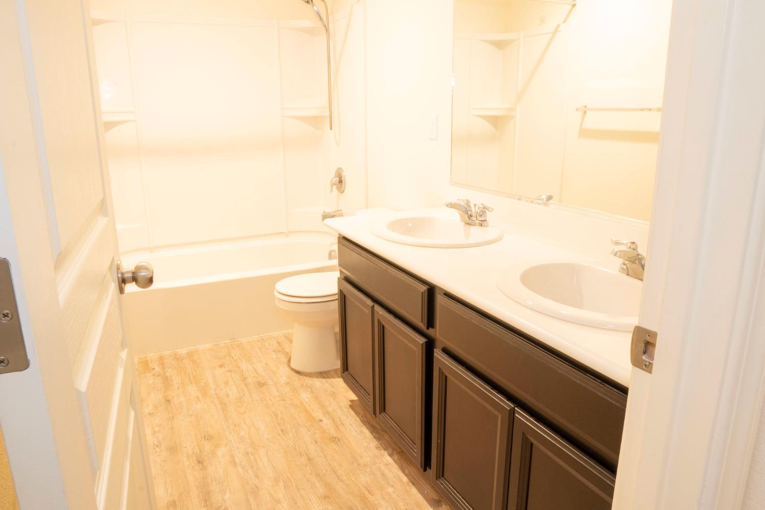 6974 East Atchison Street Fresno, CA 93727 - Photo 30 of 40 a bathroom with a sink a toilet and shower