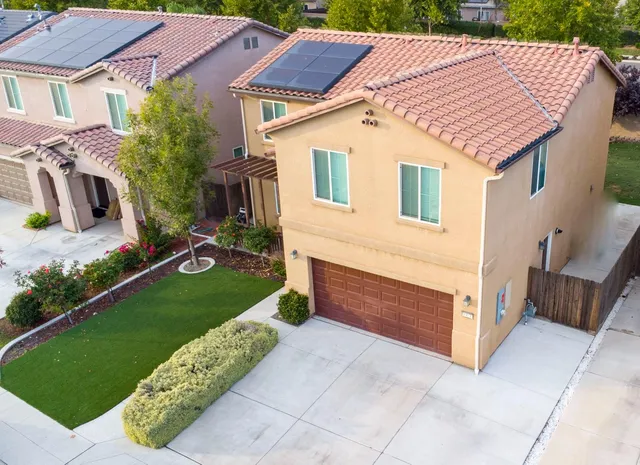 a aerial view of a house with a yard and a garage