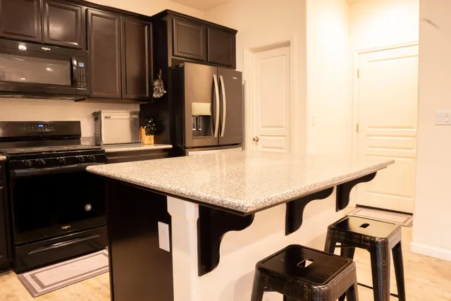 a kitchen with appliances cabinets and furniture