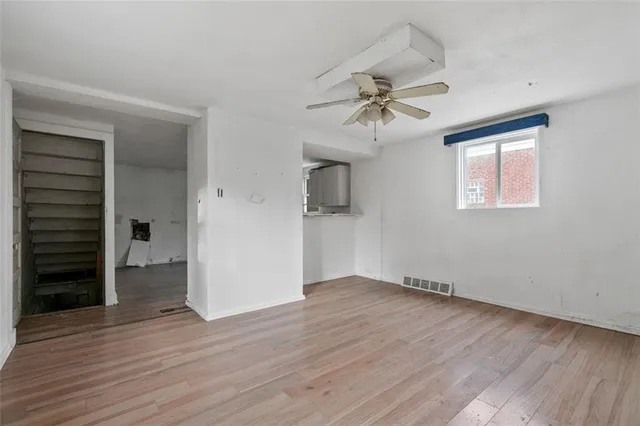 wooden floor in an empty room with a window