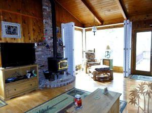 24640 Fern Valley Road Idyllwild, CA 92549 - Photo 9 of 18 a living room with furniture a flat screen tv and a fireplace