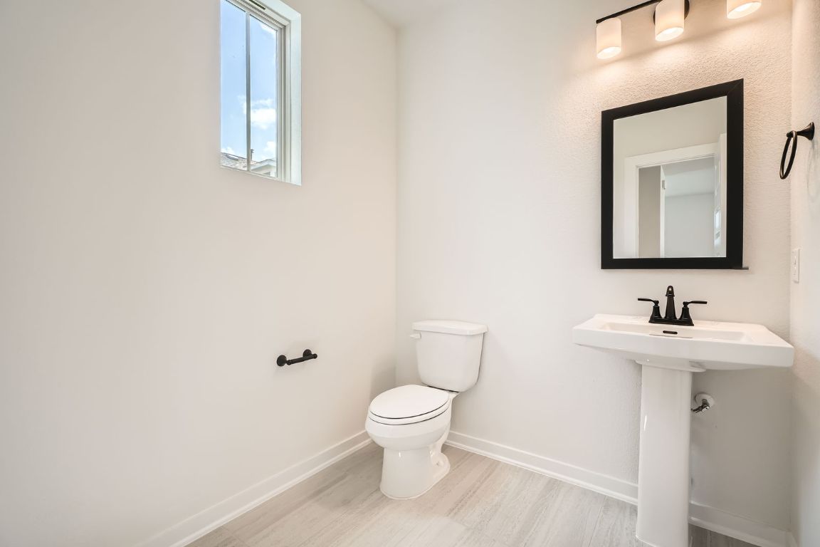 6300 Stockman Drive, Unit 5 Austin, TX 78747 - Photo 10 of 32 a bathroom with a toilet a sink and mirror