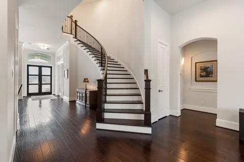a view of a room with wooden floor and stairs