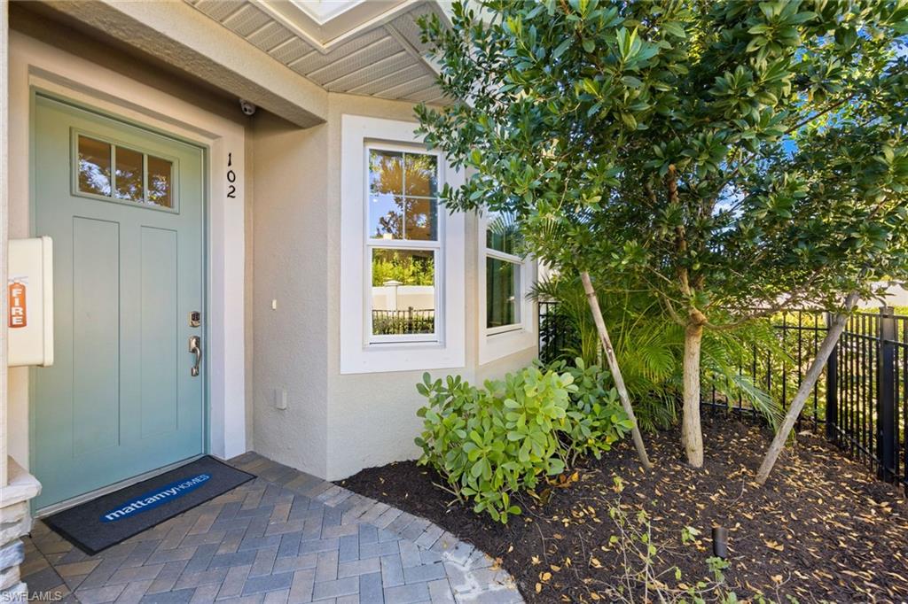 4558 Arboretum Circle, Unit 104 Naples, FL 34112 - Photo 2 of 19 a view of a house with a backyard