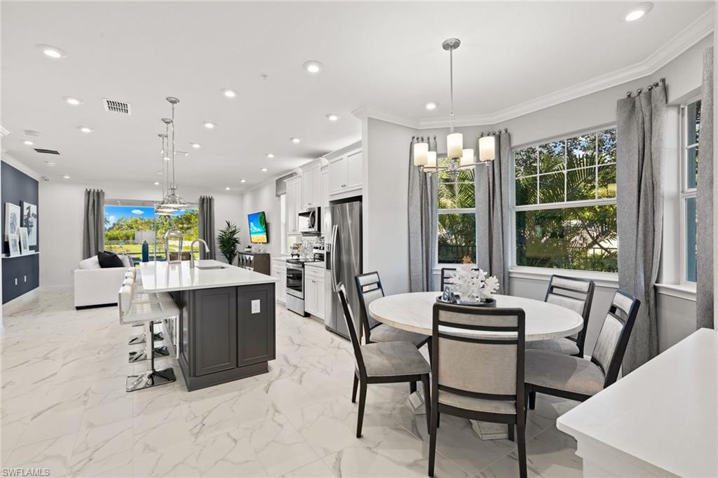 4558 Arboretum Circle, Unit 104 Naples, FL 34112 - Photo 4 of 19 a view of a dining room with furniture window and outside view
