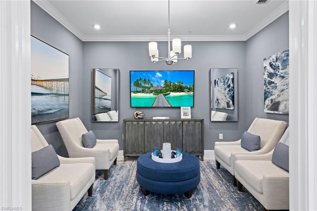 4558 Arboretum Circle, Unit 104 Naples, FL 34112 - Photo 6 of 19 a living room with furniture and a flat screen tv