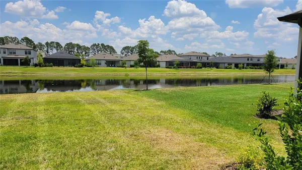 a view of a lake with houses in the background