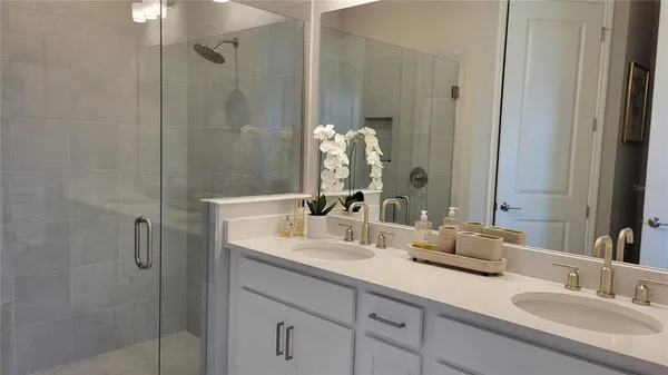 a bathroom with double sink and a mirror