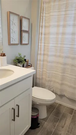 a bathroom with a sink a toilet and mirror