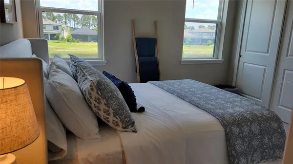 a bedroom with a bed and a window