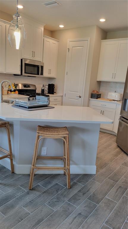 5419 Summit Glen Bradenton, FL 34203 - Photo 2 of 38 a kitchen with kitchen island granite countertop a stove a sink and a microwave