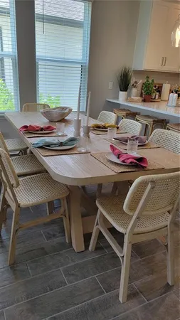 a dining room with furniture and window