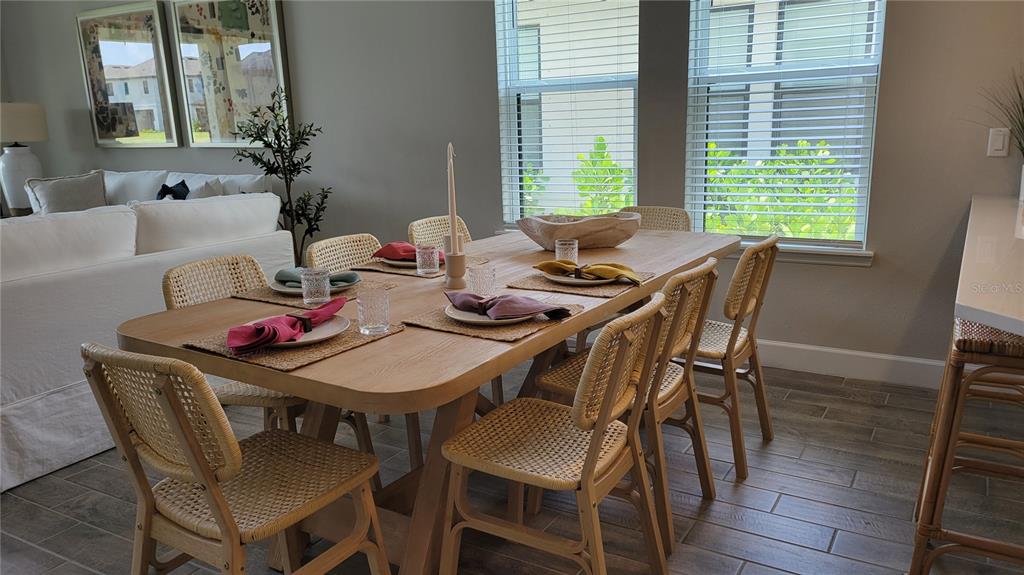 5419 Summit Glen Bradenton, FL 34203 - Photo 5 of 38 a view of a dining room with furniture and wooden floor