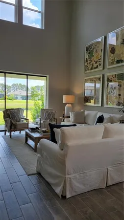 a living room with furniture and large window