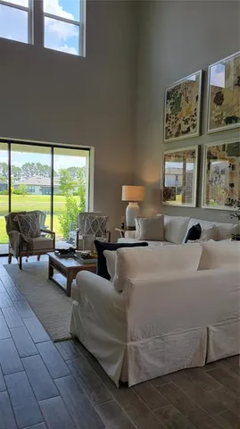 a living room with furniture and large window