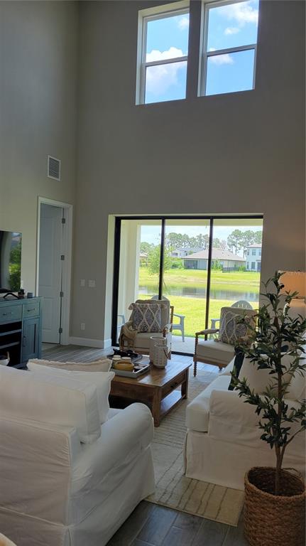 5419 Summit Glen Bradenton, FL 34203 - Photo 7 of 38 a living room with furniture and floor to ceiling windows